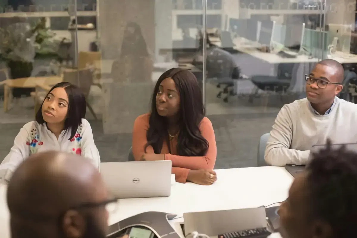 Colleagues gathered around a table in a team meeting