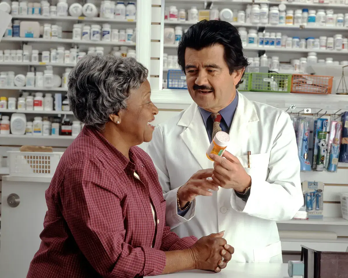 A pharmacist explaining a prescription to a customer