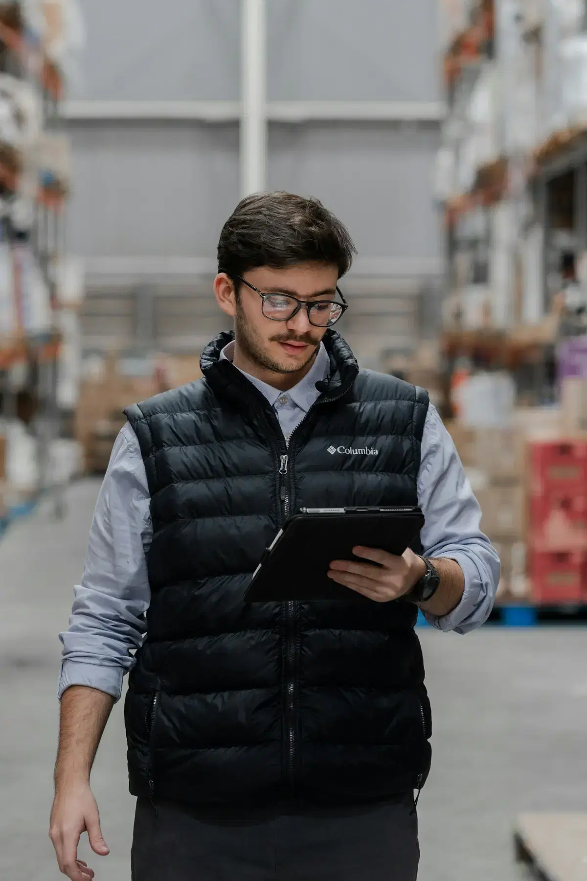 A warehouse manager tracking shipments on a tablet